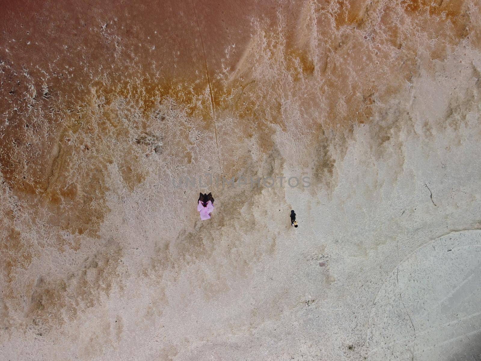 Aerial drone footage of a pink salt lake on a beautiful summer evening. Aerial view of a dried pink salt lake on a beautiful summer evening. Aerial view of a drying out salt lake.