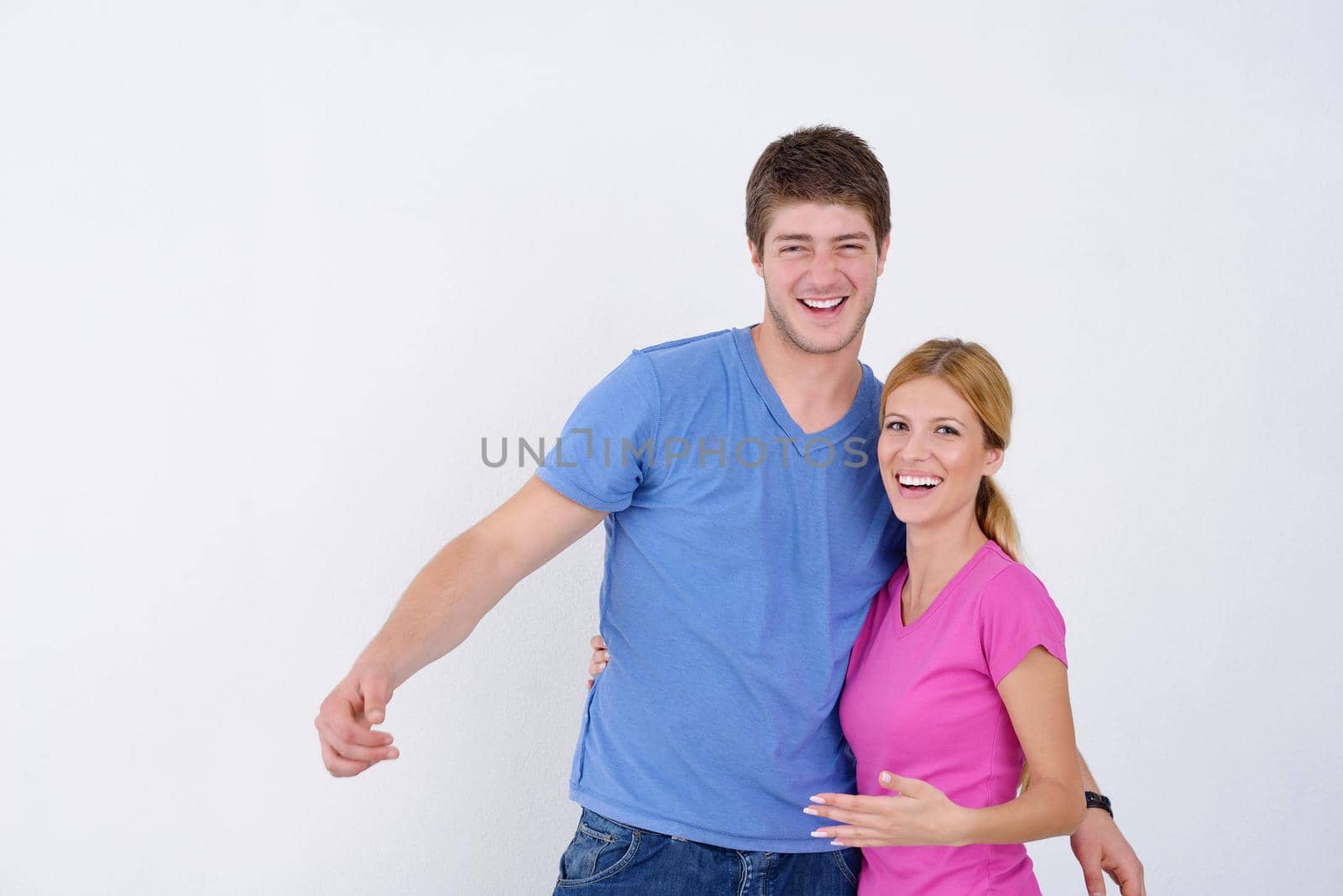 happy young couple paint in green and blue color white wall of their new home