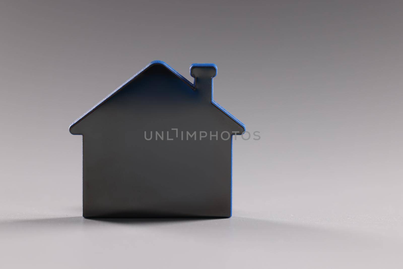 Mock up toy house standing on gray background closeup by kuprevich
