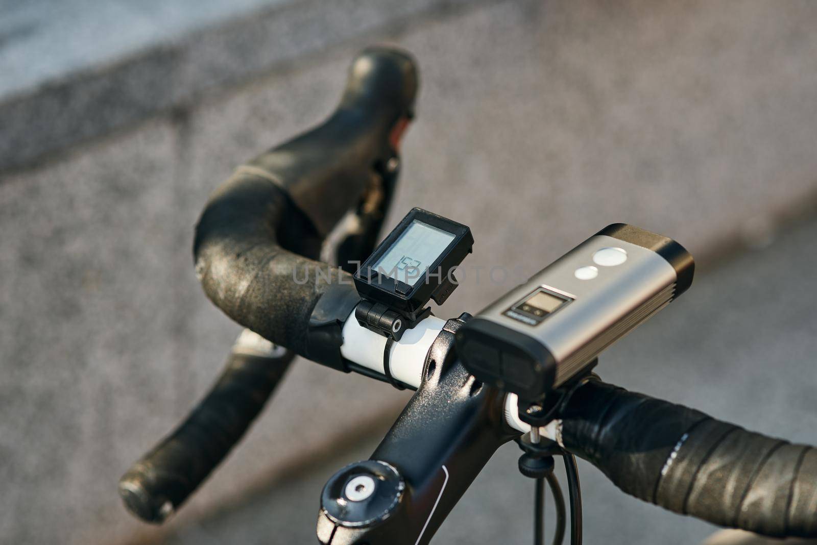 Close up shot of equipment and accessories attached to professional bike handlebar. Sports, extreme and active lifestyle concept. Selective focus