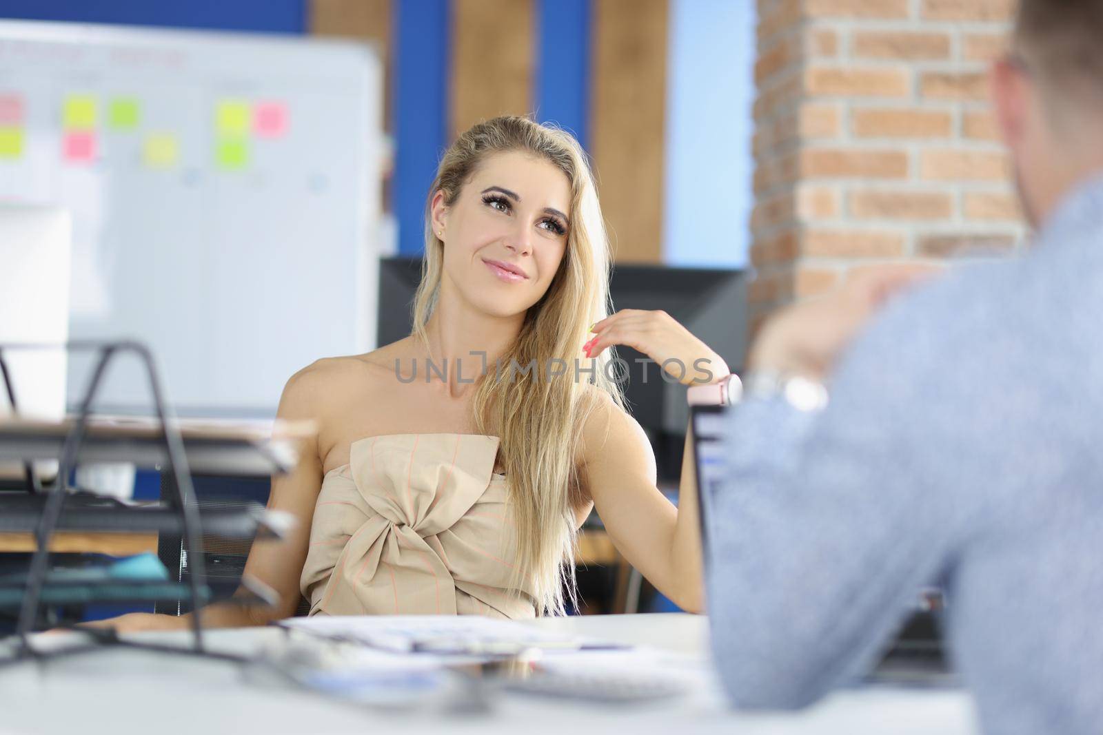 Portrait of attractive female sitting on boss seat, control big corporation, female company leader. Businesswoman interview man for work. Business concept