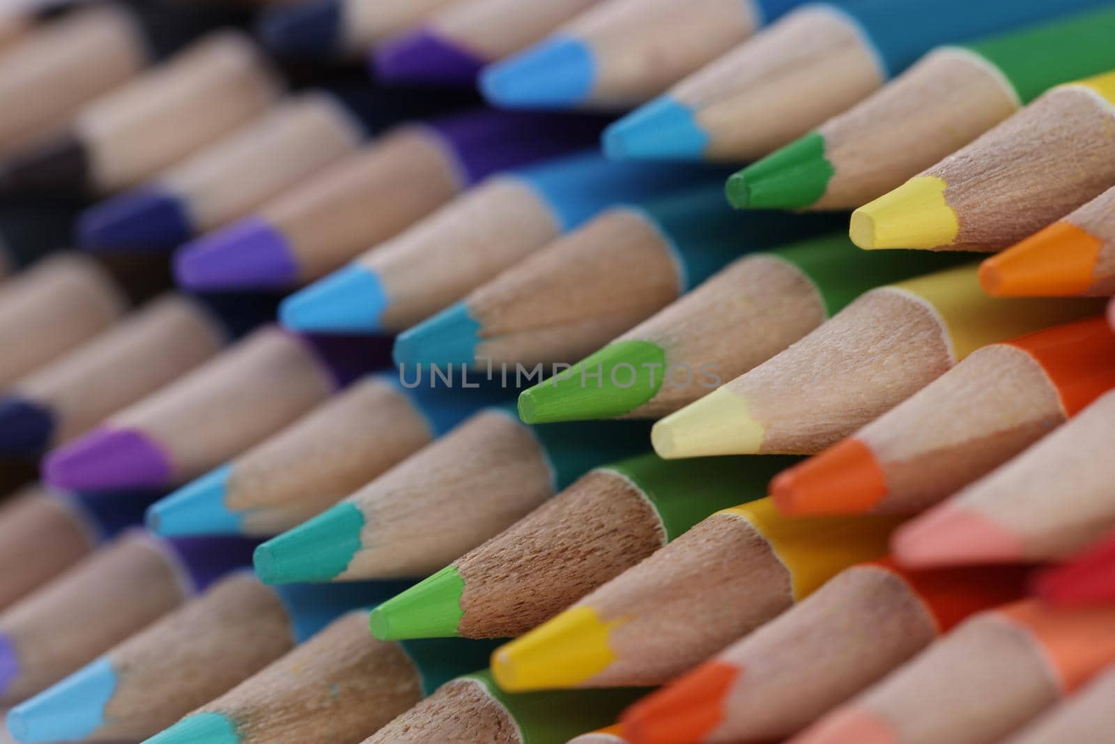 Close-up of sharpened pencils for drawing laying on each other forming repeated stack. Pigmented crayons for drawing. Vision, idea, imagination concept