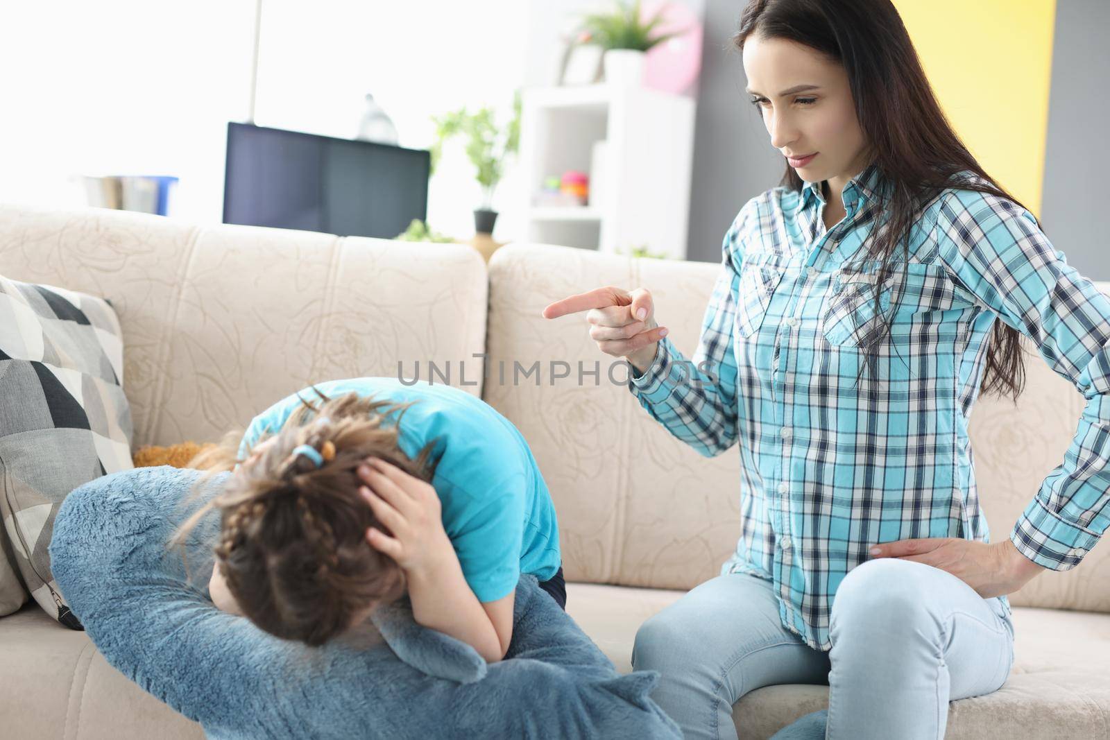 Portrait of millennial mother screaming shouting on little girl daughter. Complicated relations, misunderstanding conflict in family. Punishment concept