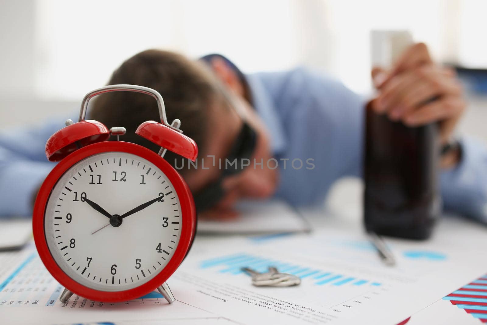 Red vintage clock show time, drunk man fell asleep on workplace in office by kuprevich