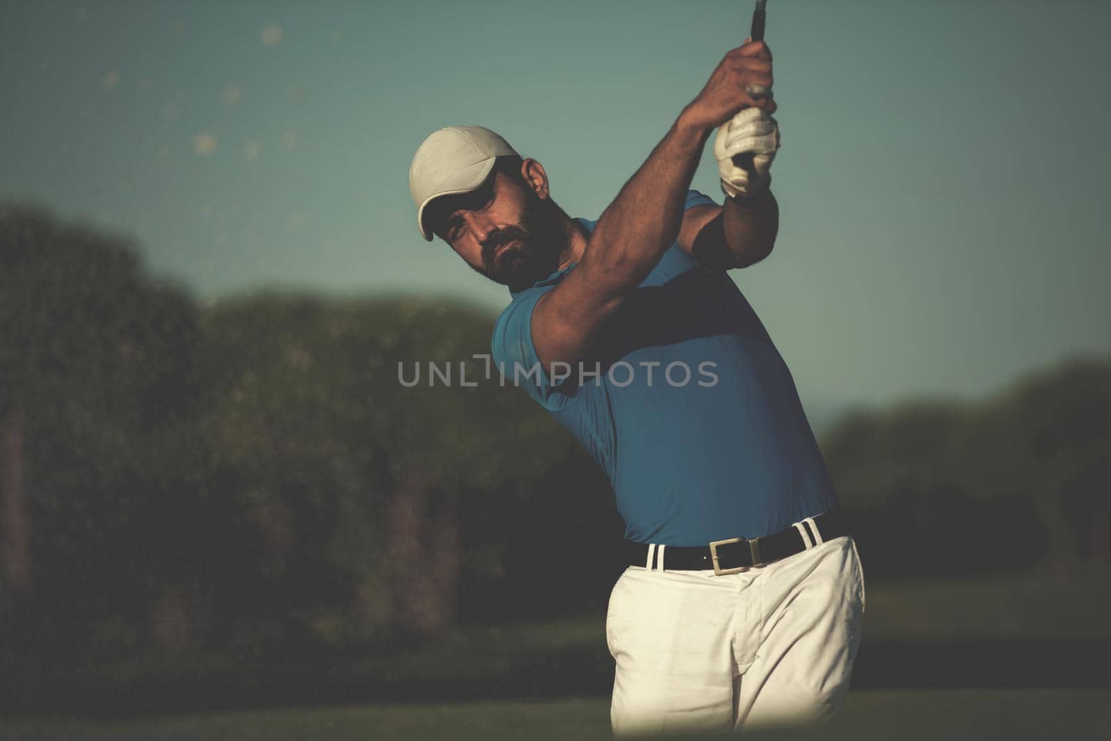 pro golfer hitting a sand bunker shot by dotshock