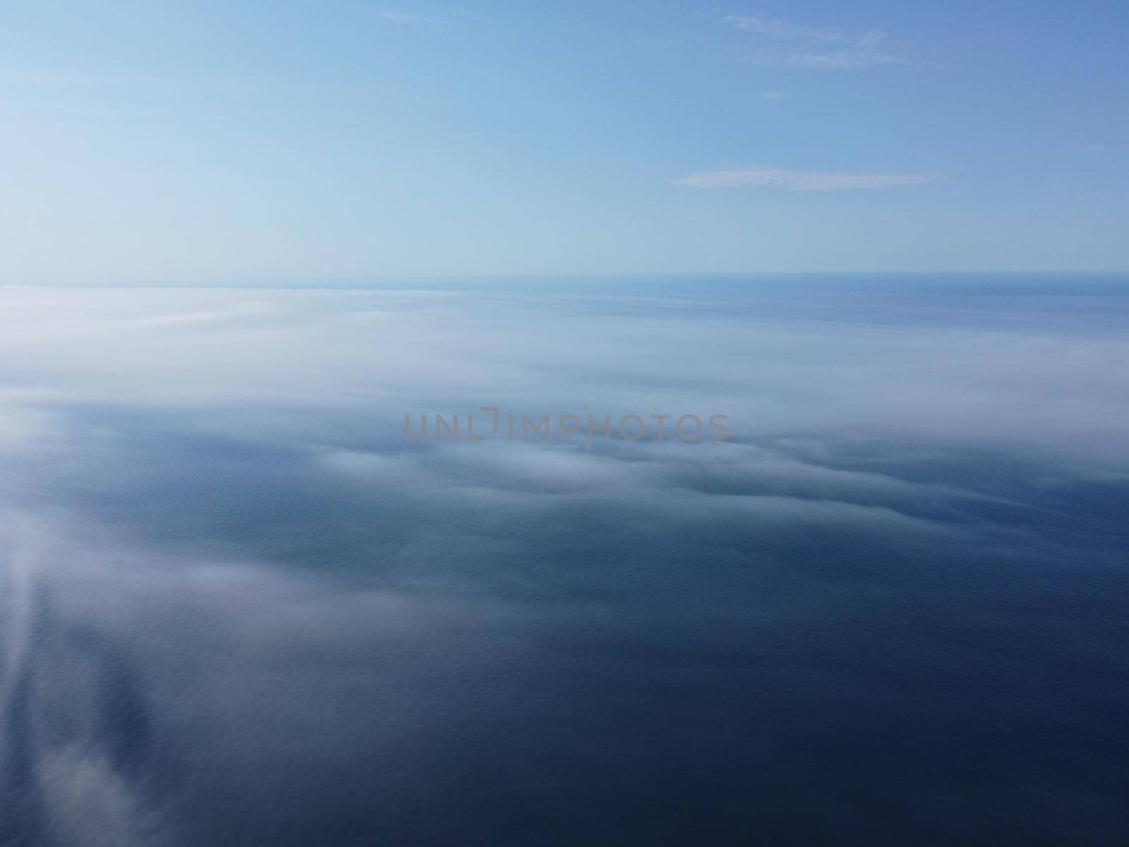 Abstract nature summer or spring ocean sea background. Small waves on water surface in motion blur with bokeh lights from sunrise.