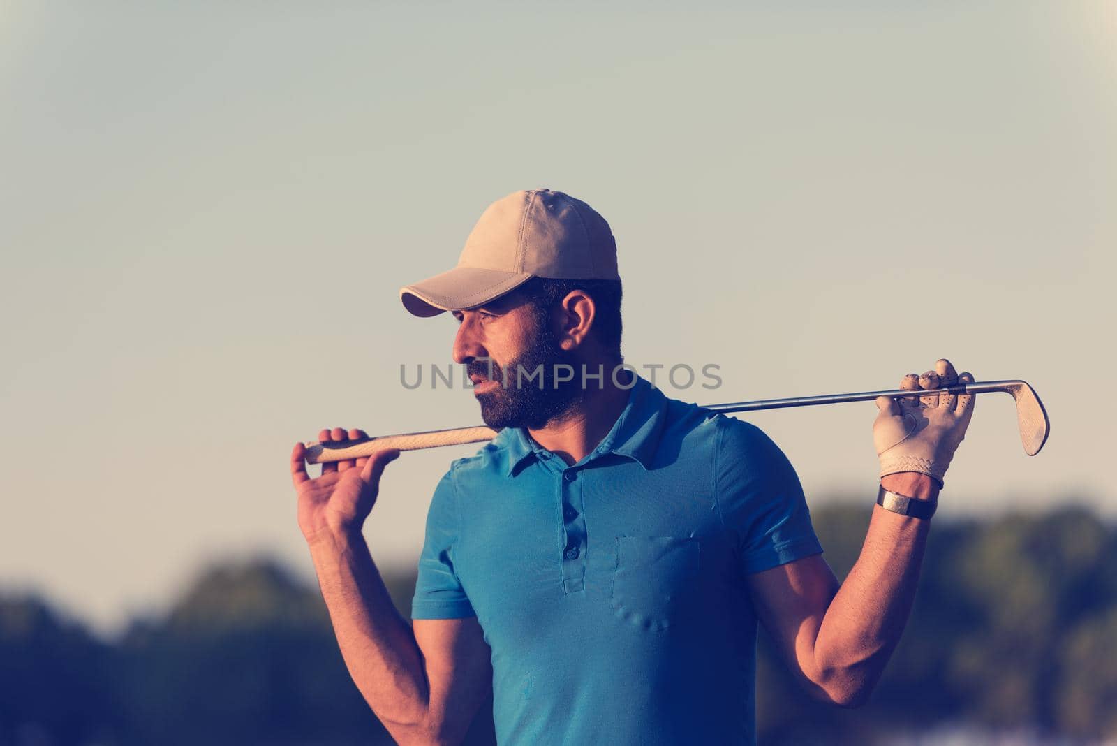 golfer  portrait at golf course on sunset by dotshock