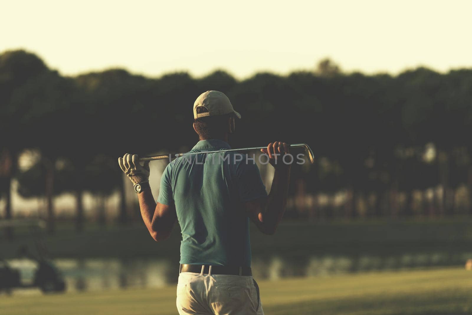 golfer from back at course looking to hole in distance by dotshock