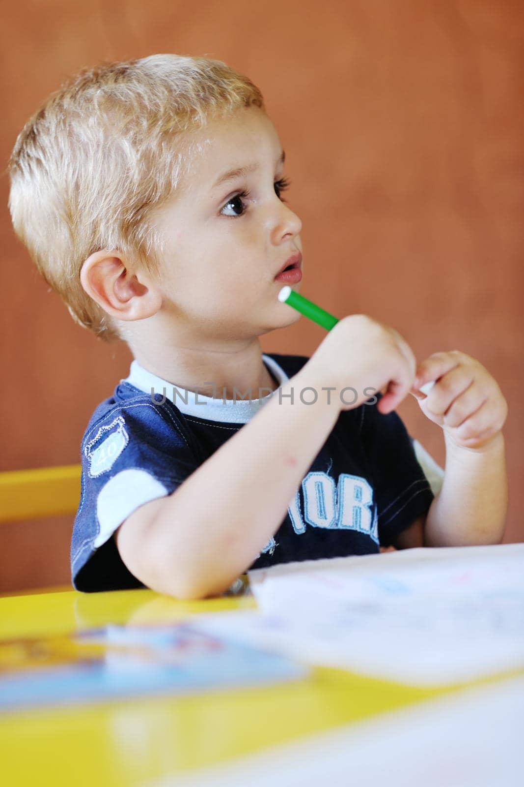 happy little child play game and have fun, education lessons in colorful kinder garden playground indoors