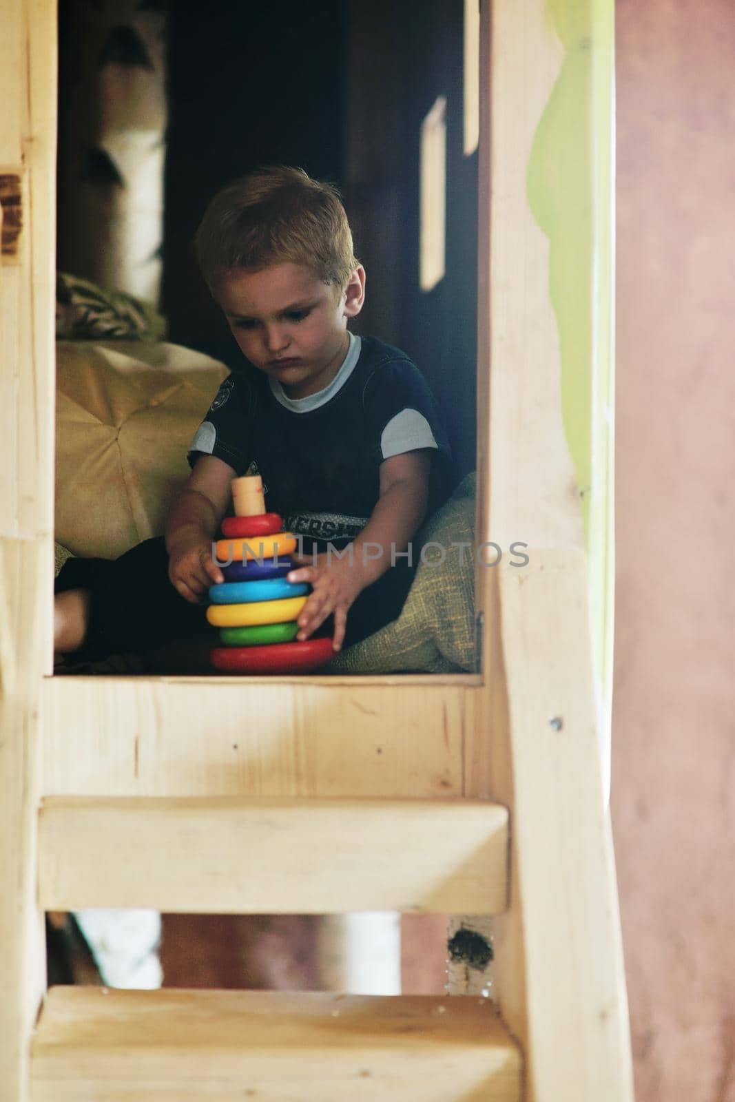 happy little child play game and have fun, education lessons in colorful kinder garden playground indoors