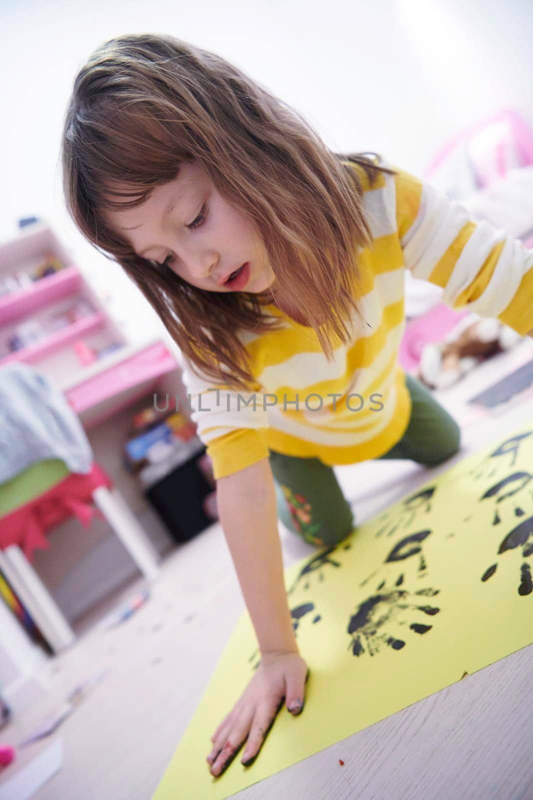 cute little girl at home painting with hands funny no tooth smile