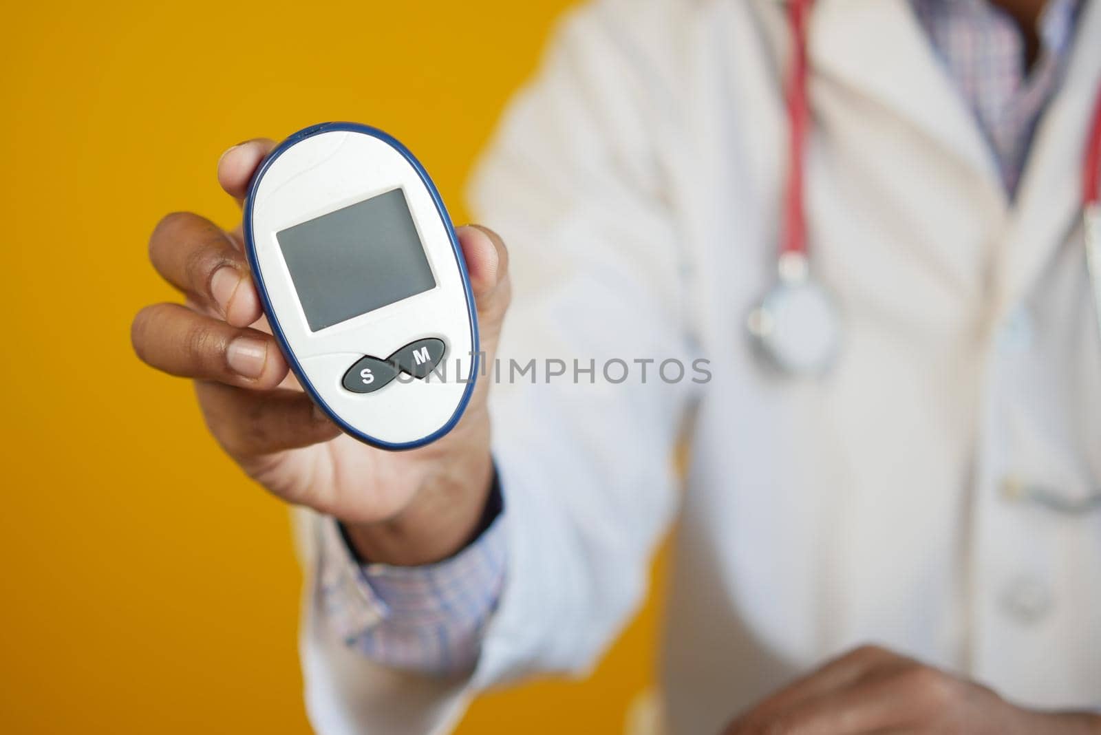 man's hand putting glucose meter in a small bag .