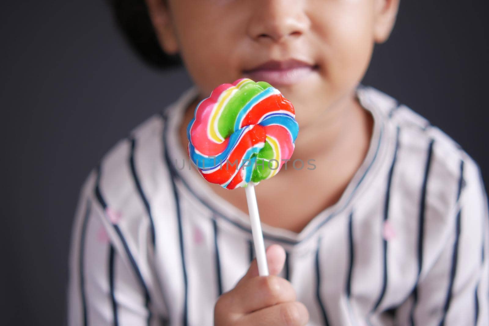 hand hold rainbow heart shape lollipop by towfiq007