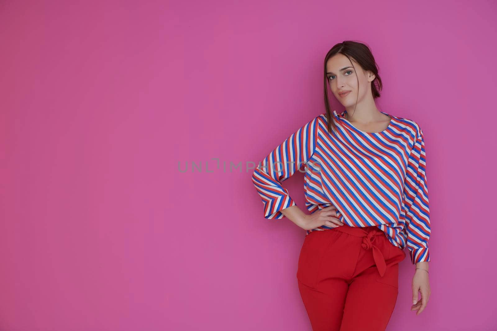 Portrait of young woman posing in the studio by dotshock