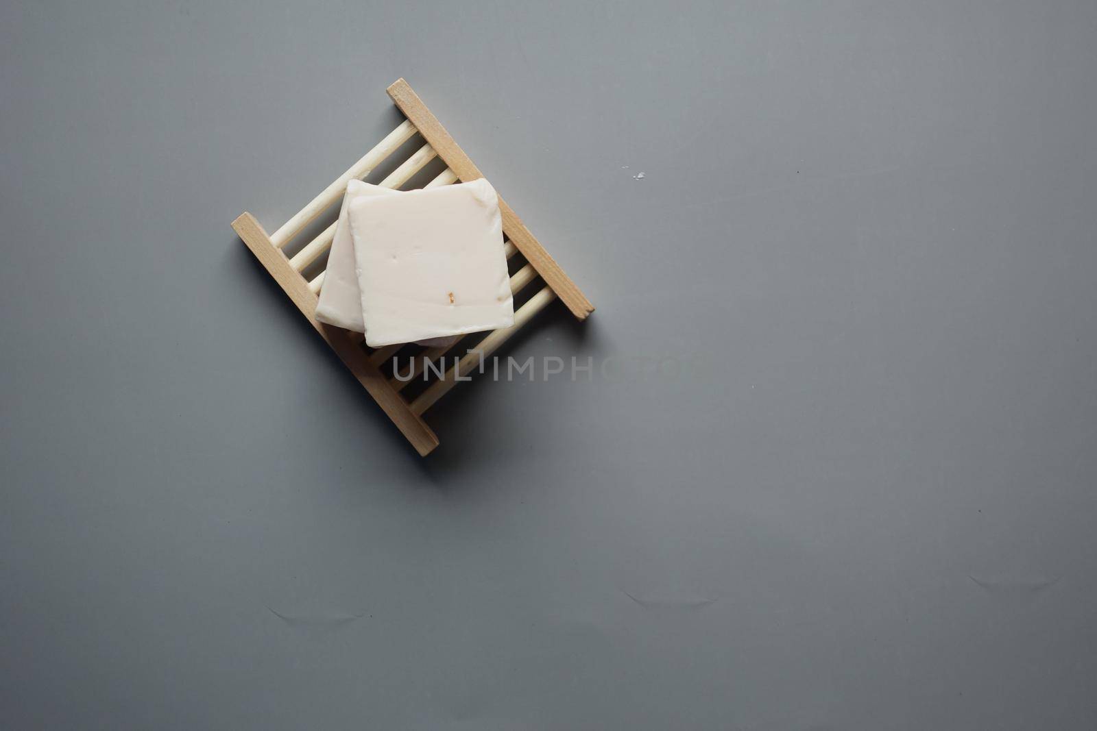 Homemade natural soap bar on black background .