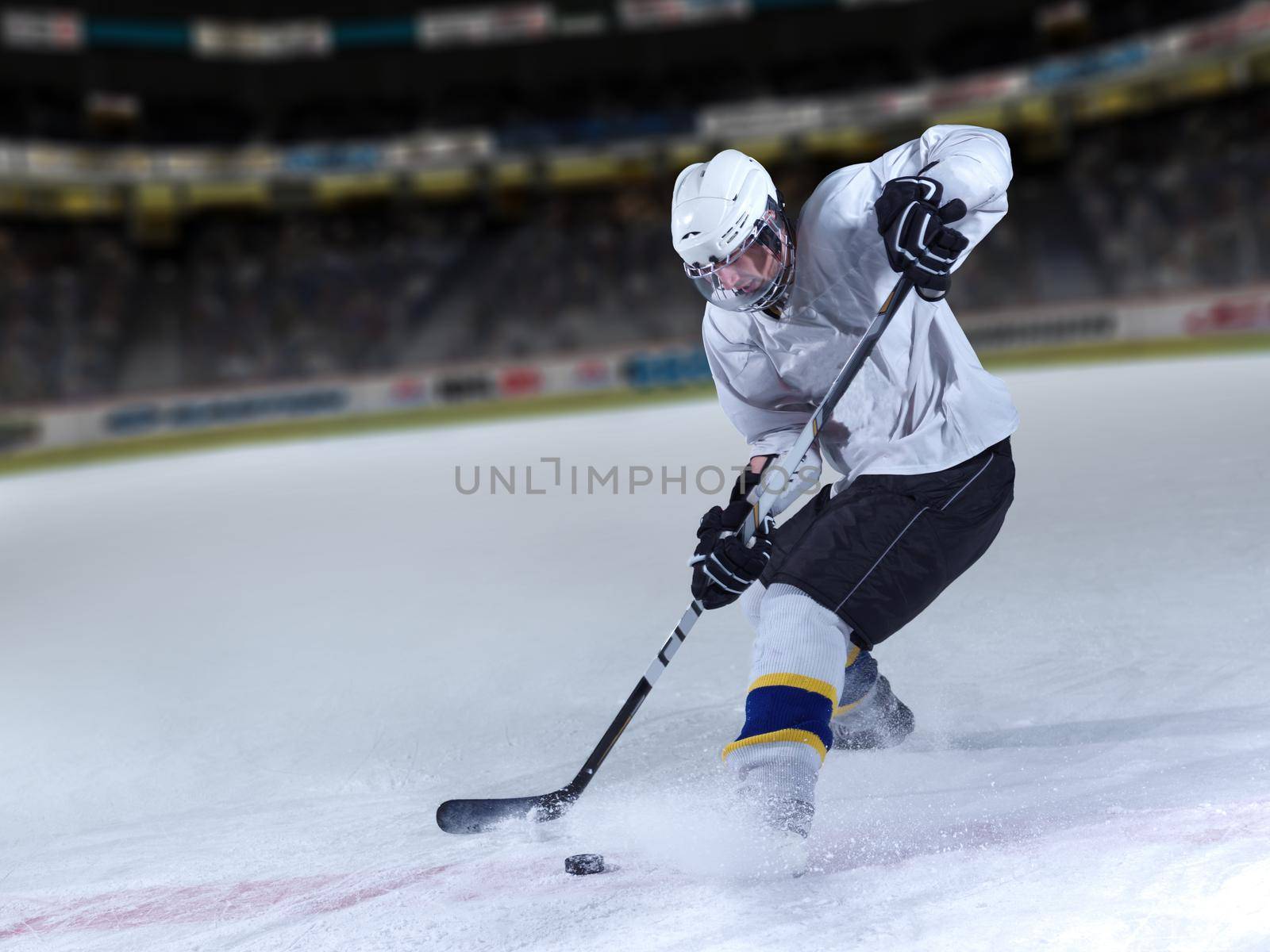 ice hockey player in action kicking with stick