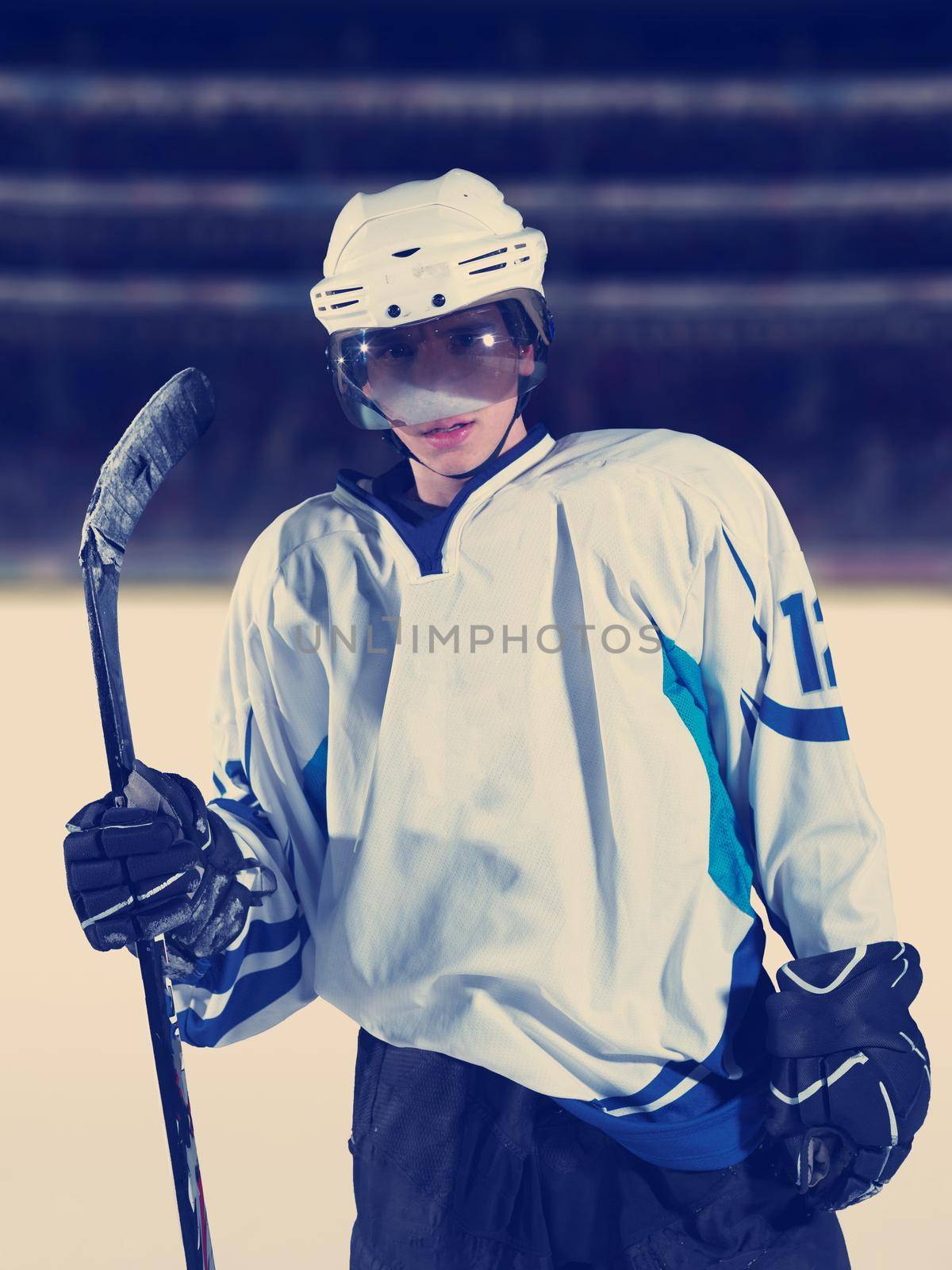 young ice hockey player portrait on training in black background