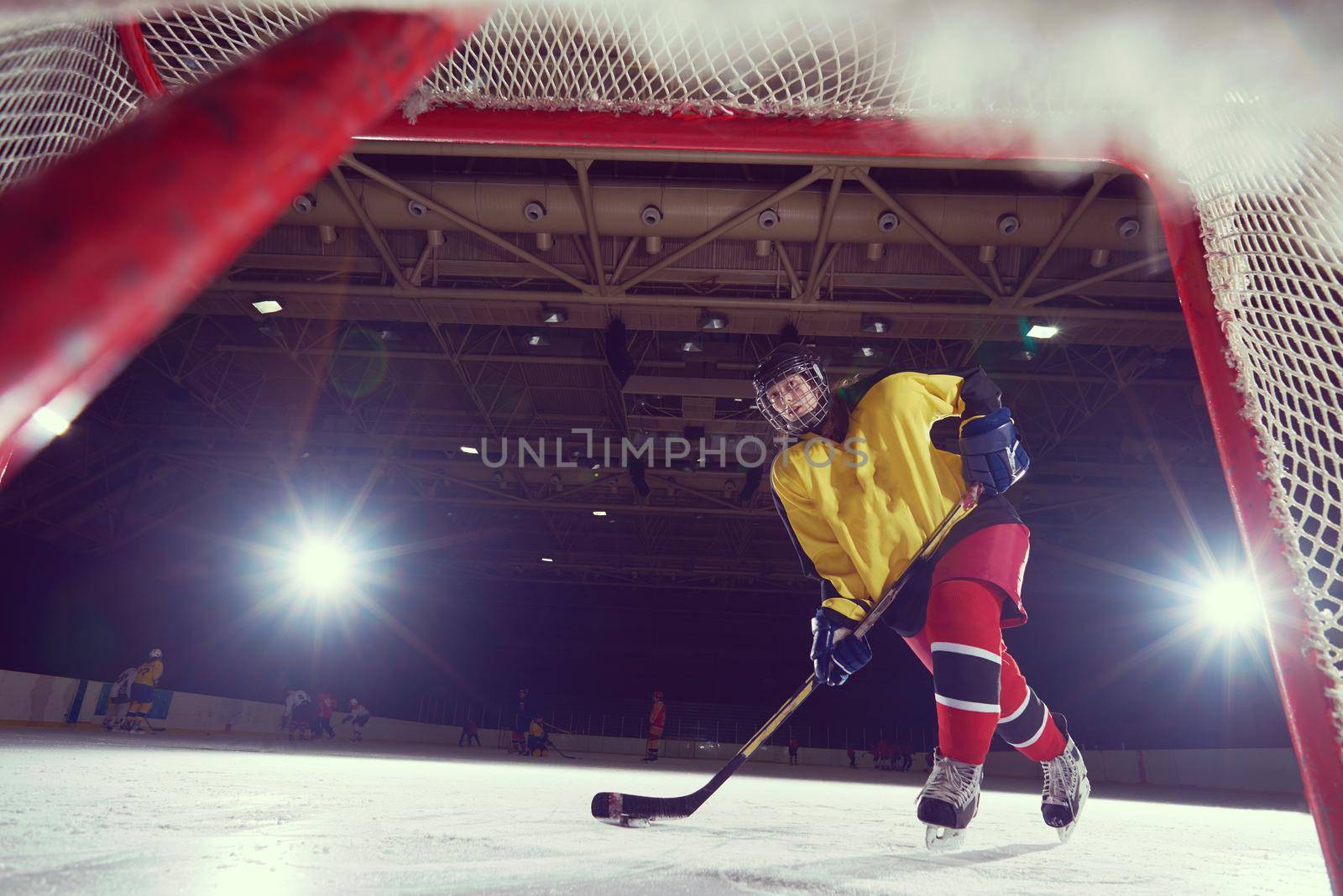 teen ice hockey player in action by dotshock