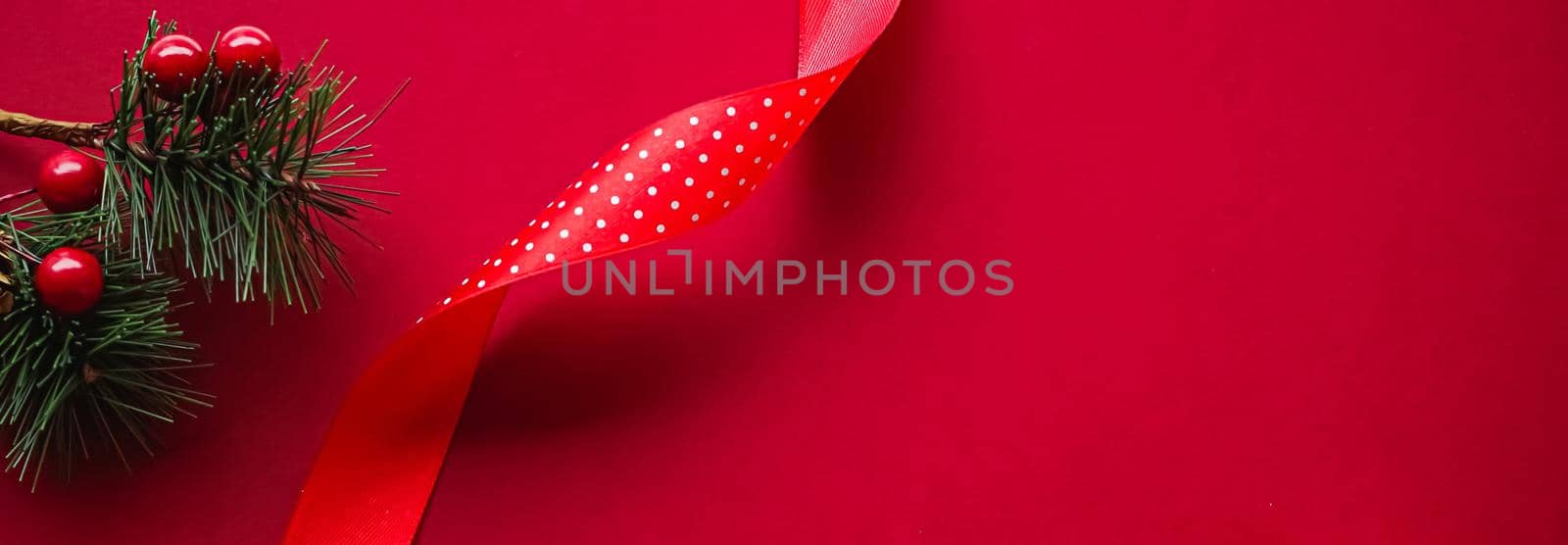 Christmas flatlay and holiday design concept. Decoration, ornament and xmas gift wrapping on red paper background as flat lay top view.