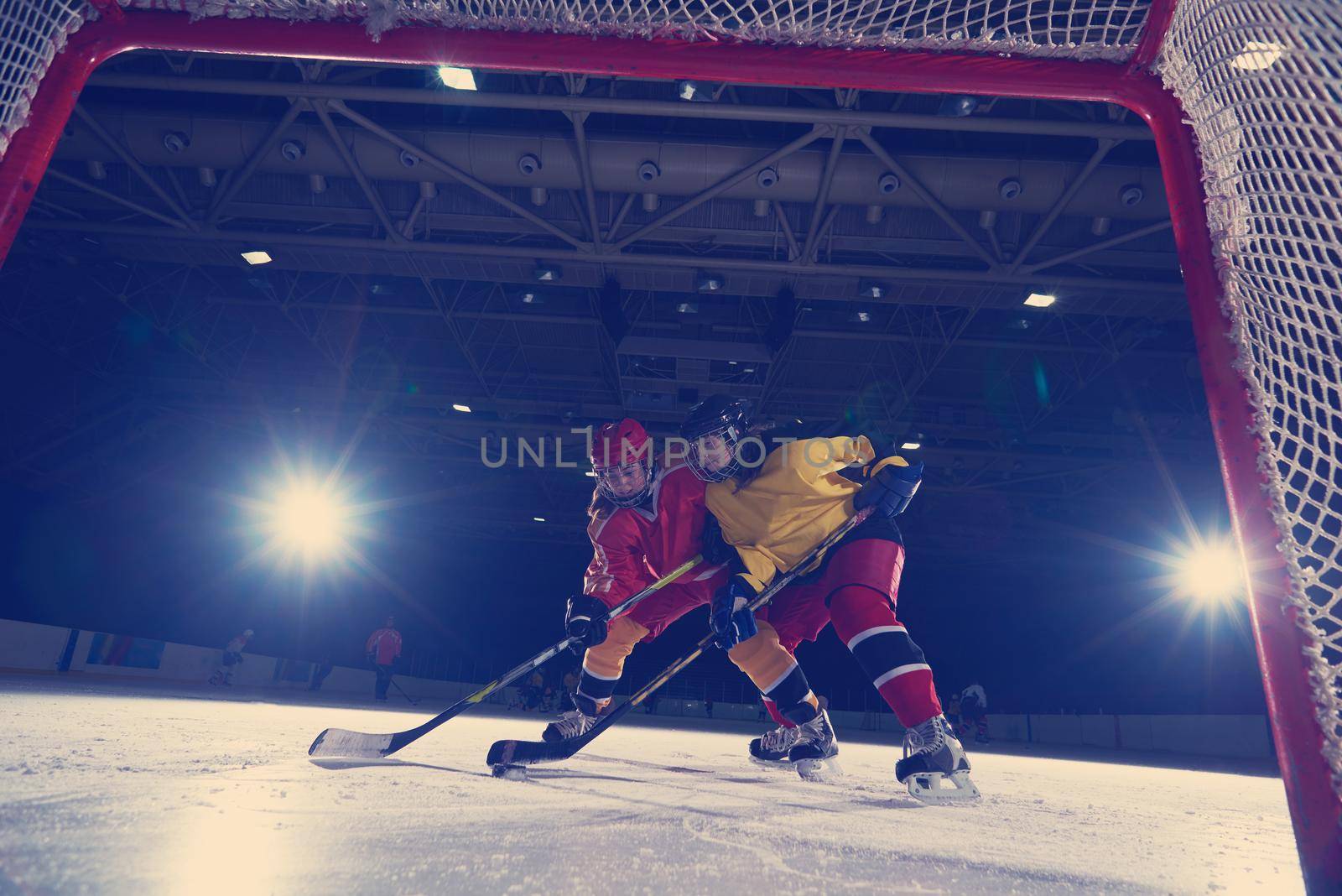 teen ice hockey sport  players in action by dotshock