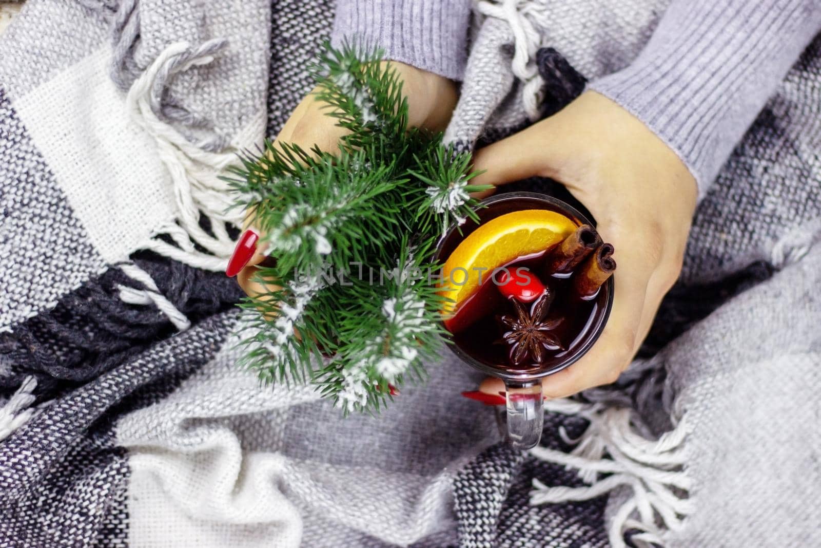 Hot mulled wine in male and female hands, spices. by Anuta23