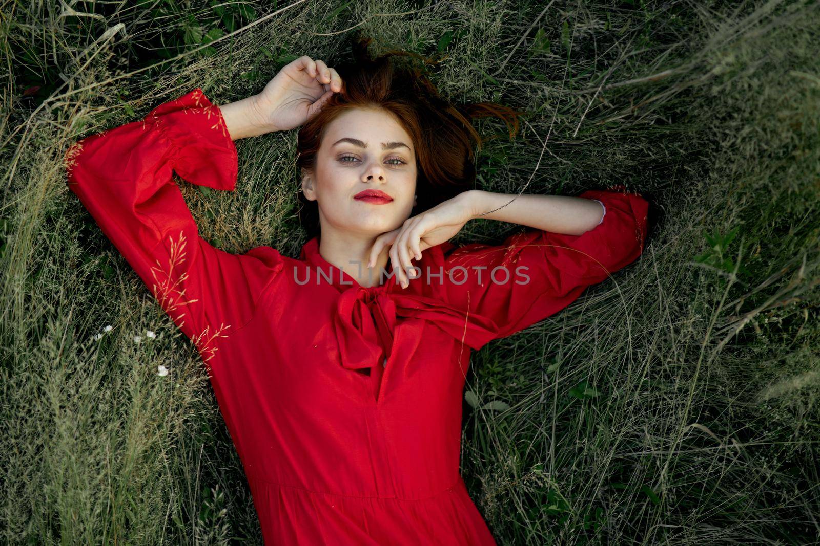 woman in red dress lies on the grass nature freedom summer by Vichizh