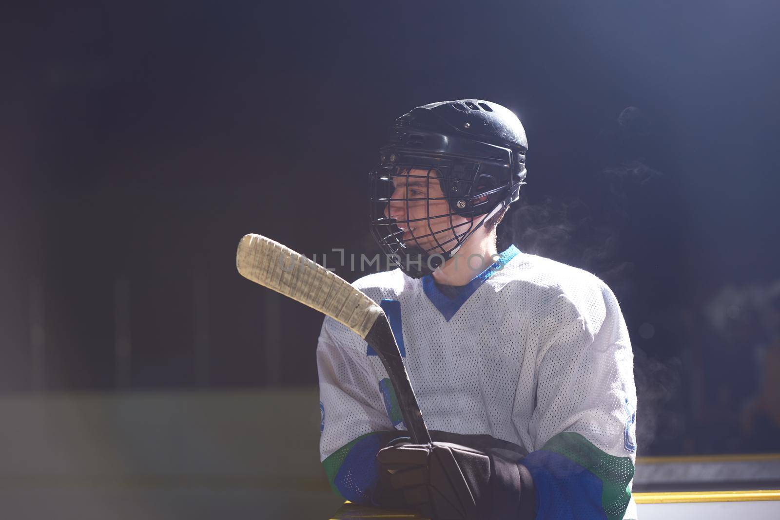 young ice hockey player portrait on training in black background