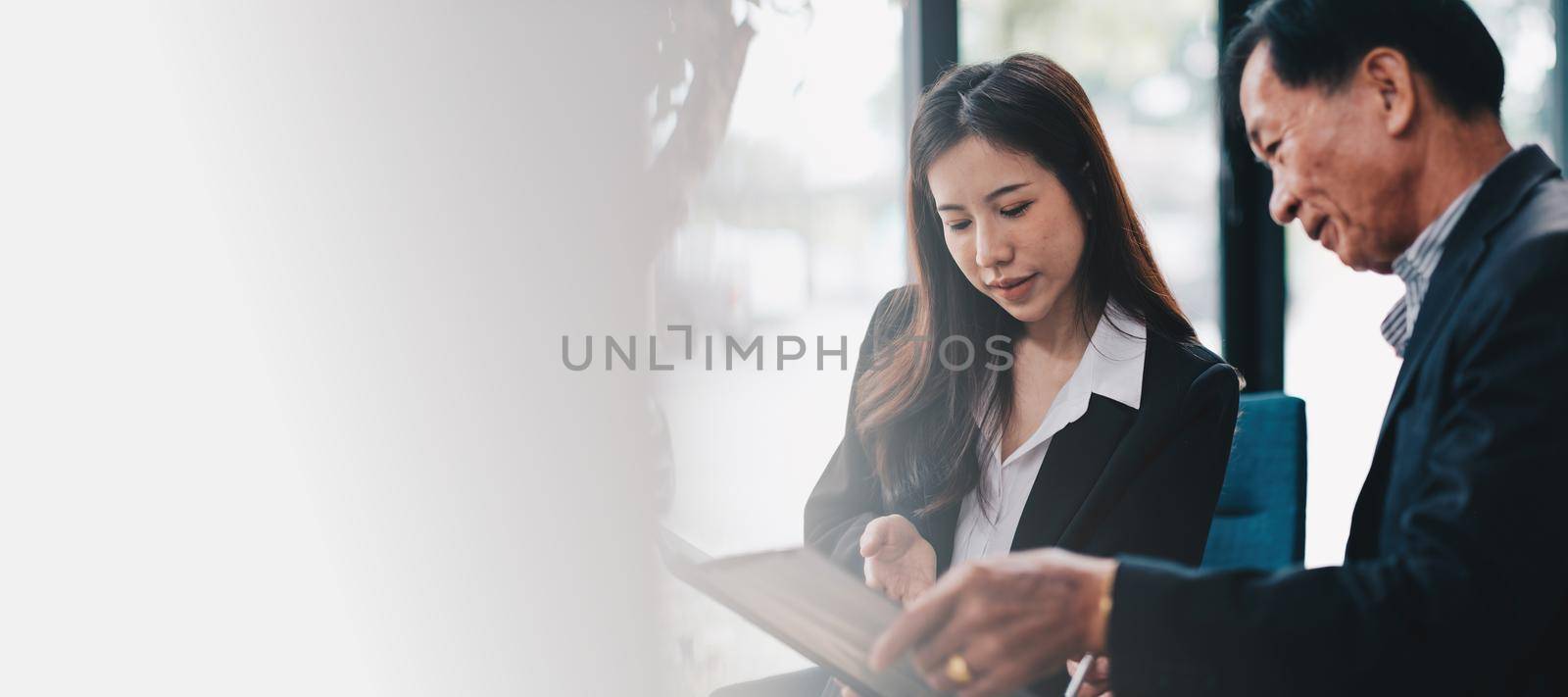 Senior man planning their investments with financial advisor, Young female consultant with calculator.