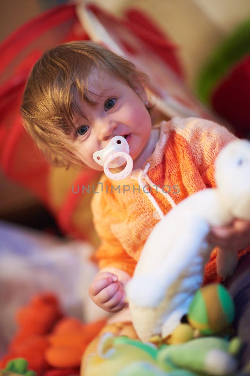 cute little child baby girl  playing with toys at home