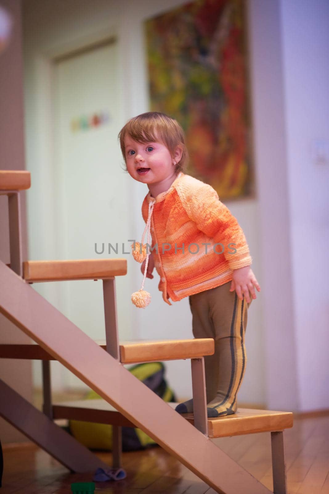 cute little child baby girl  playing with toys at home