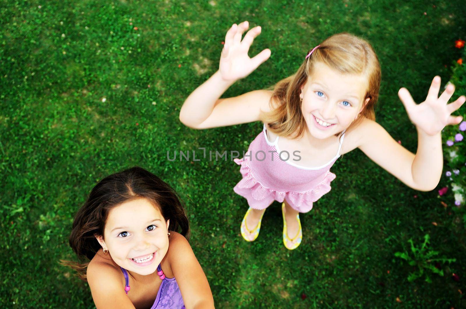 two happy young girls children  have fun outdoor in nature