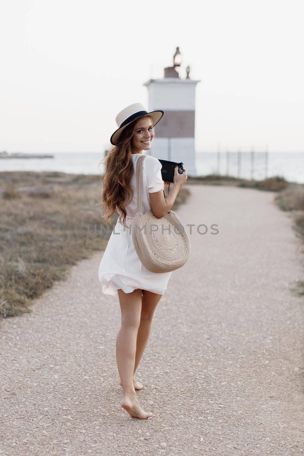 happy young woman with camera outdoor by splash