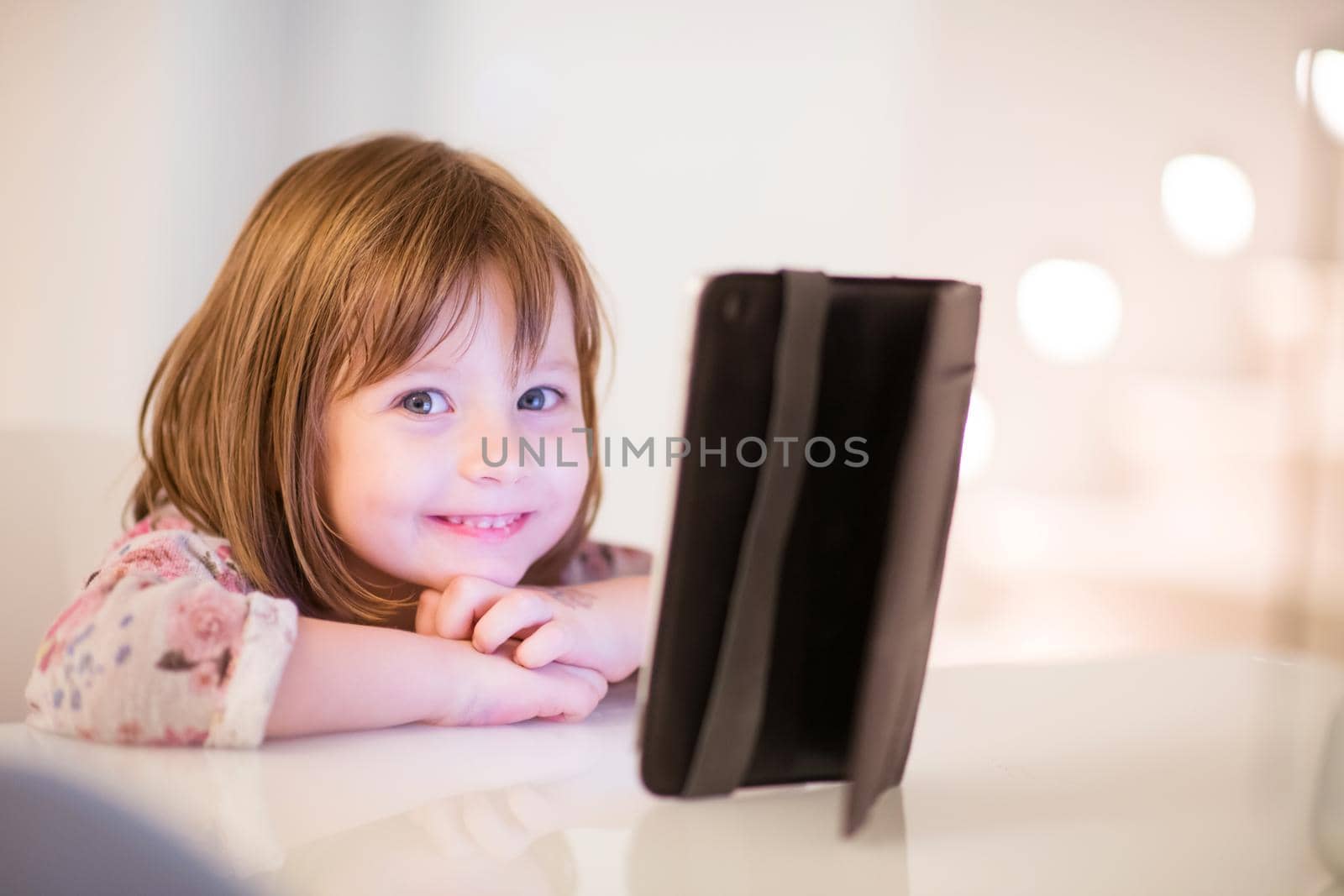 child playing with digital tablet by dotshock
