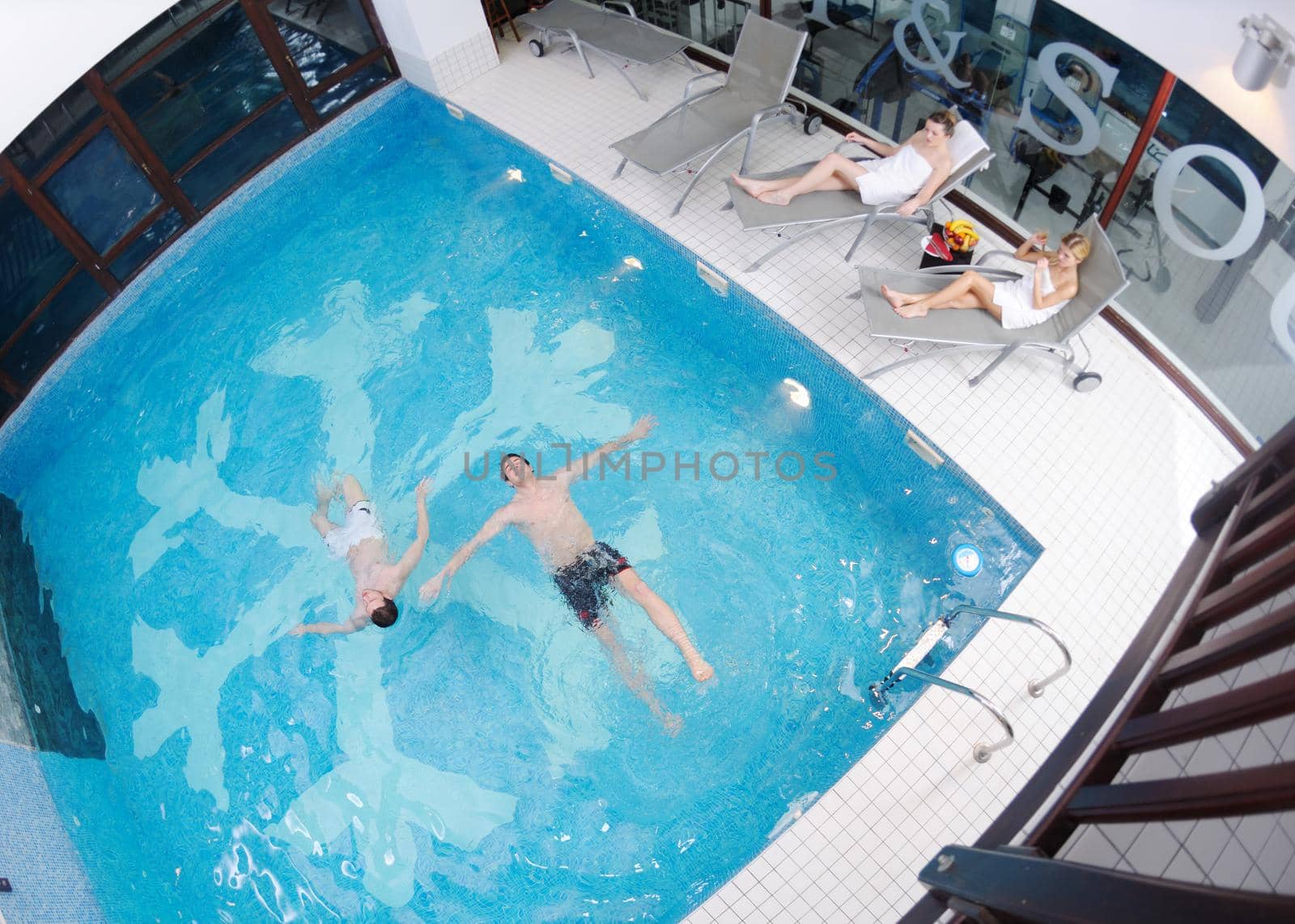 young people group at spa swimming pool by dotshock