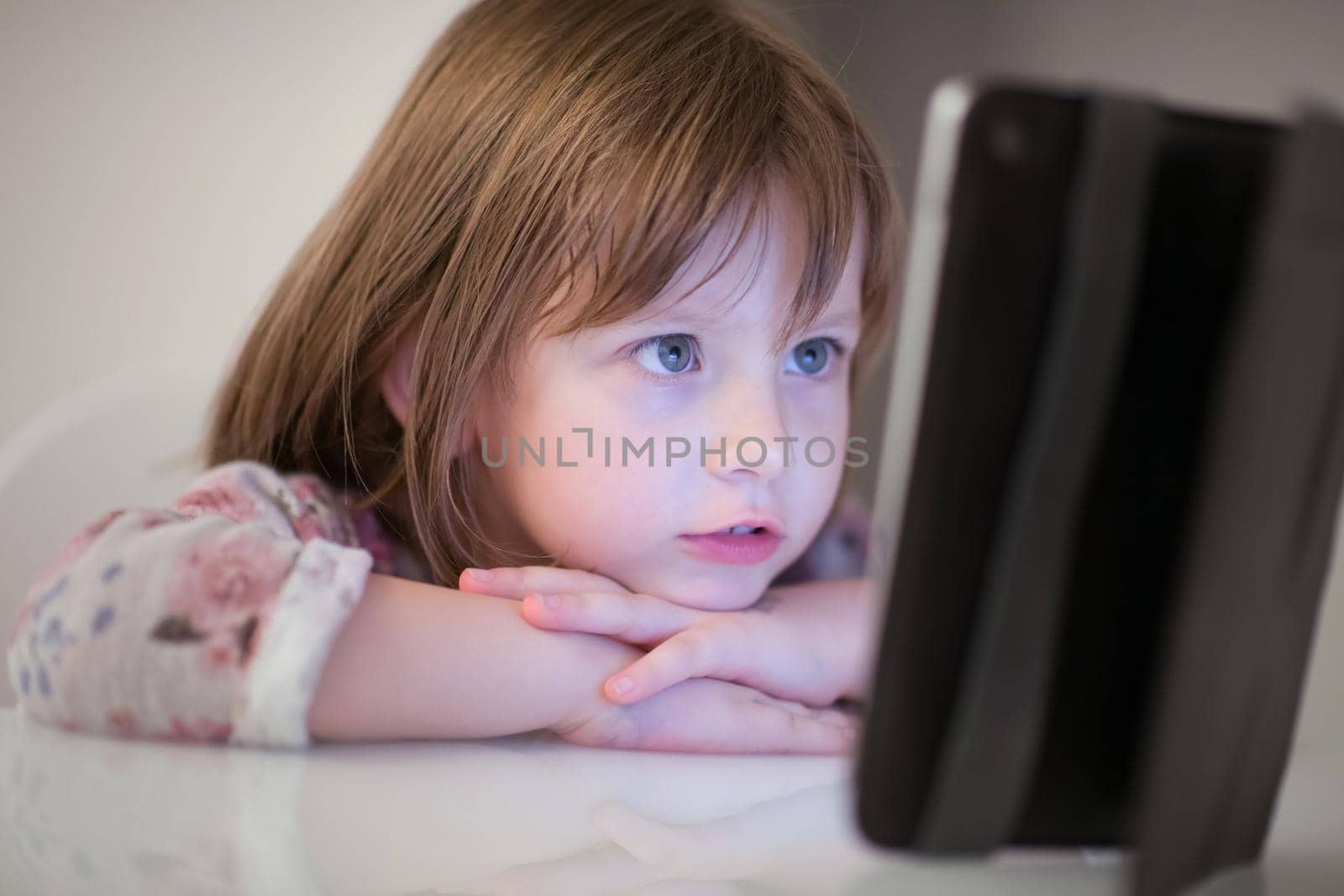 child playing with digital tablet at home
