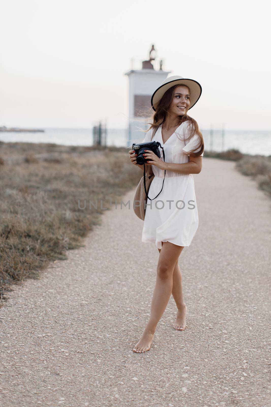 happy young woman with camera outdoor by splash