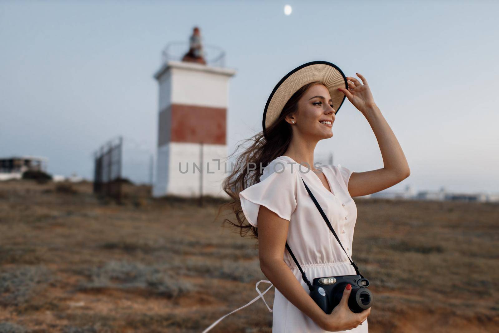 happy young woman with camera outdoor by splash