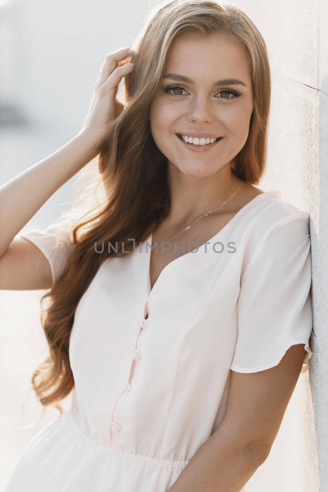 Young happy smiling woman in hat outdoor by splash