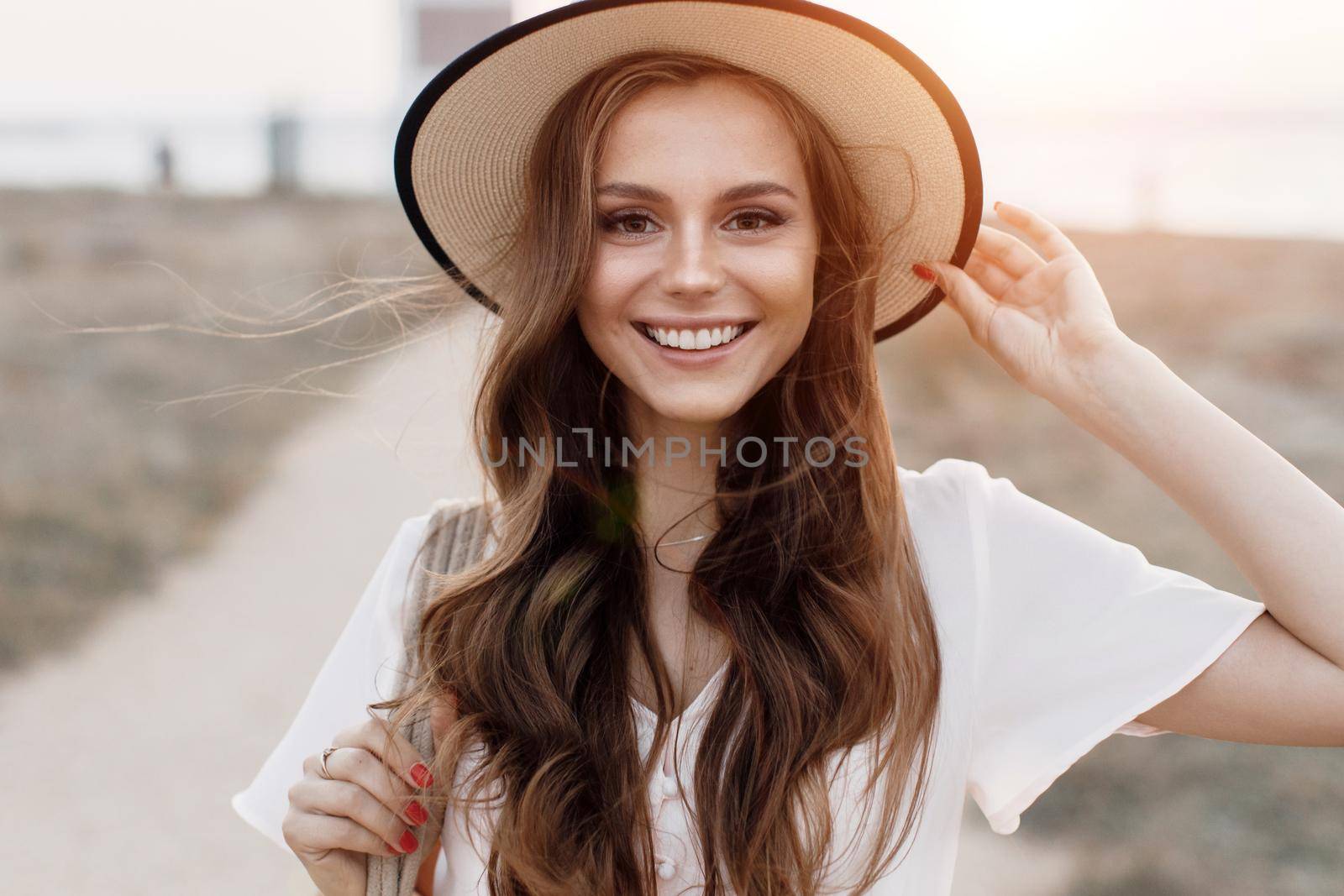 Young happy woman in hat outdoor. High quality photo