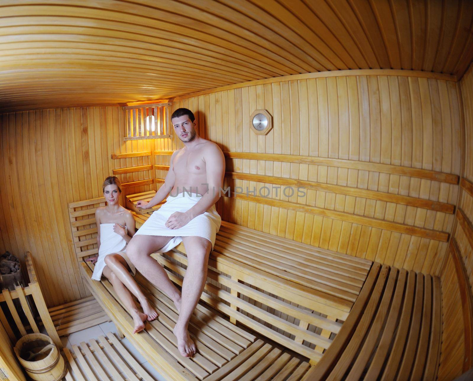 happy young couple in sauna by dotshock