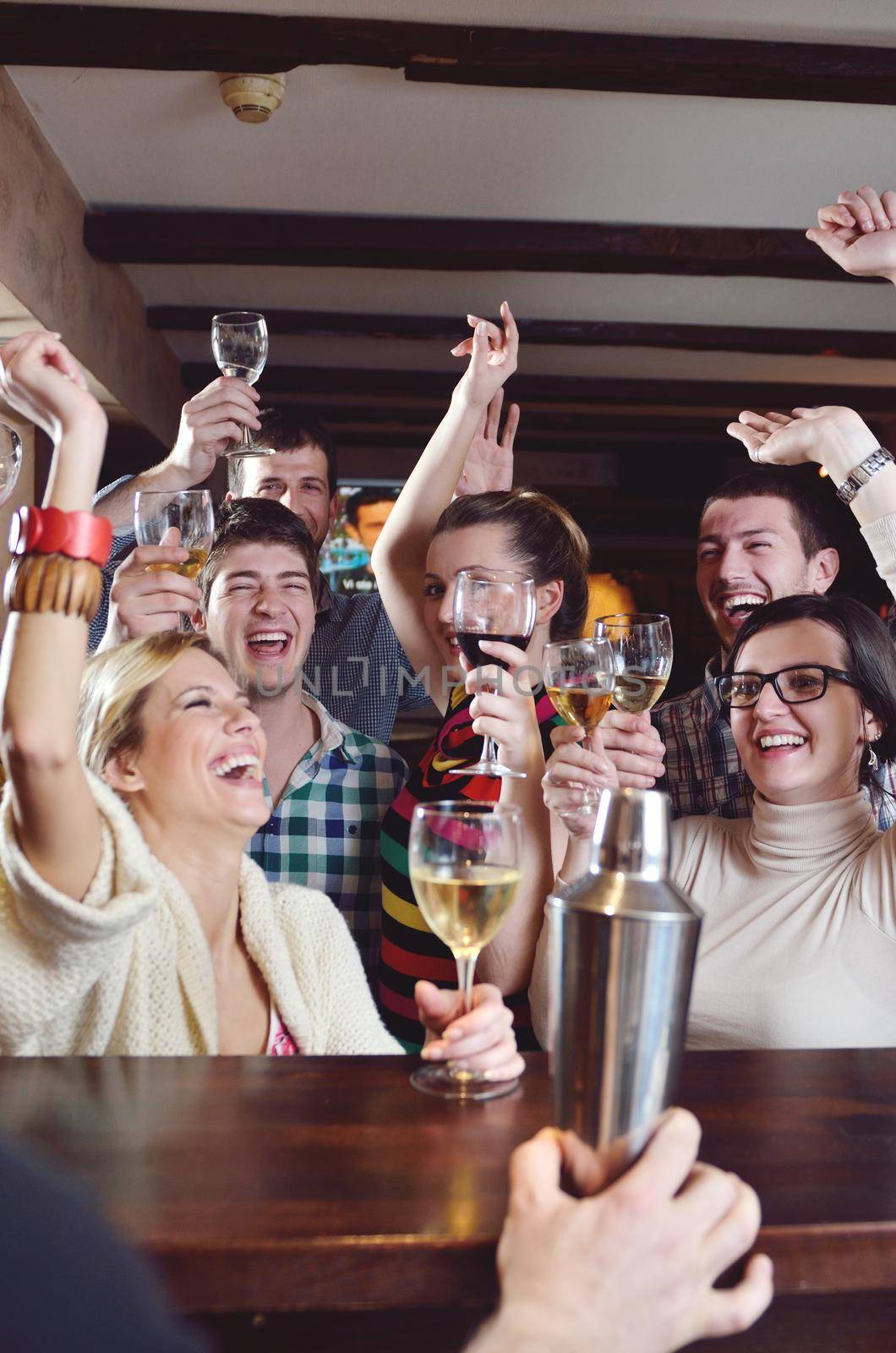 Group of happy young people drink wine  at party disco restaurant