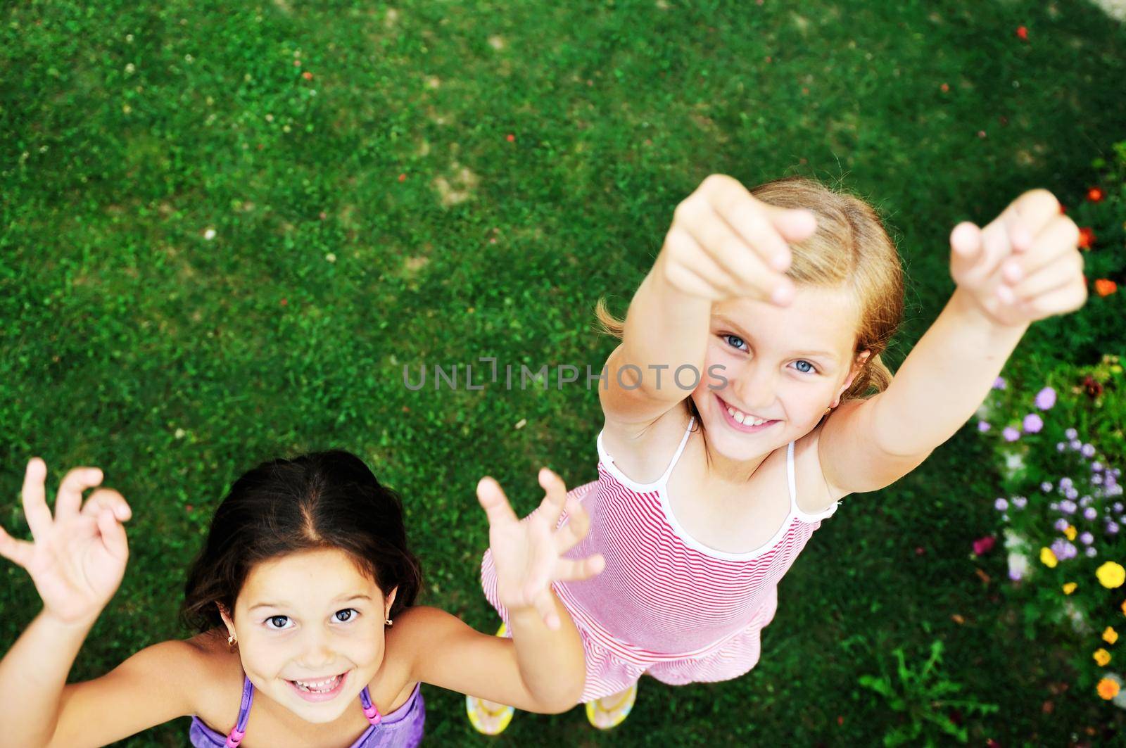 two happy young girls children  have fun outdoor in nature