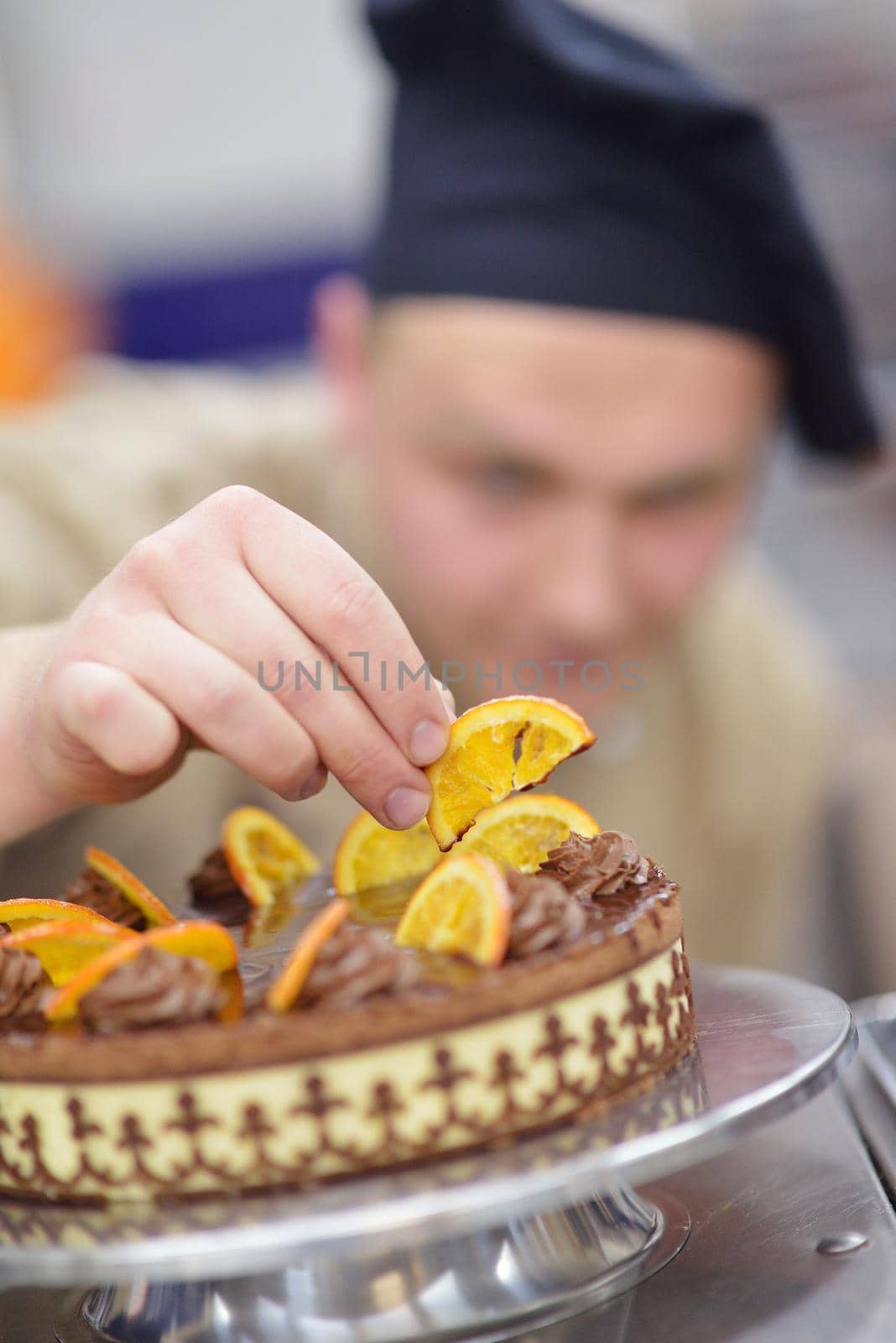 chef preparing desert cake in the kitchen by dotshock