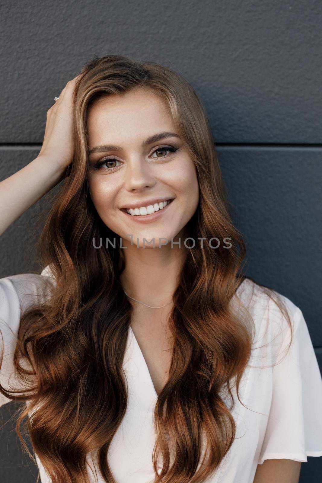 Young happy smiling woman in hat outdoor by splash