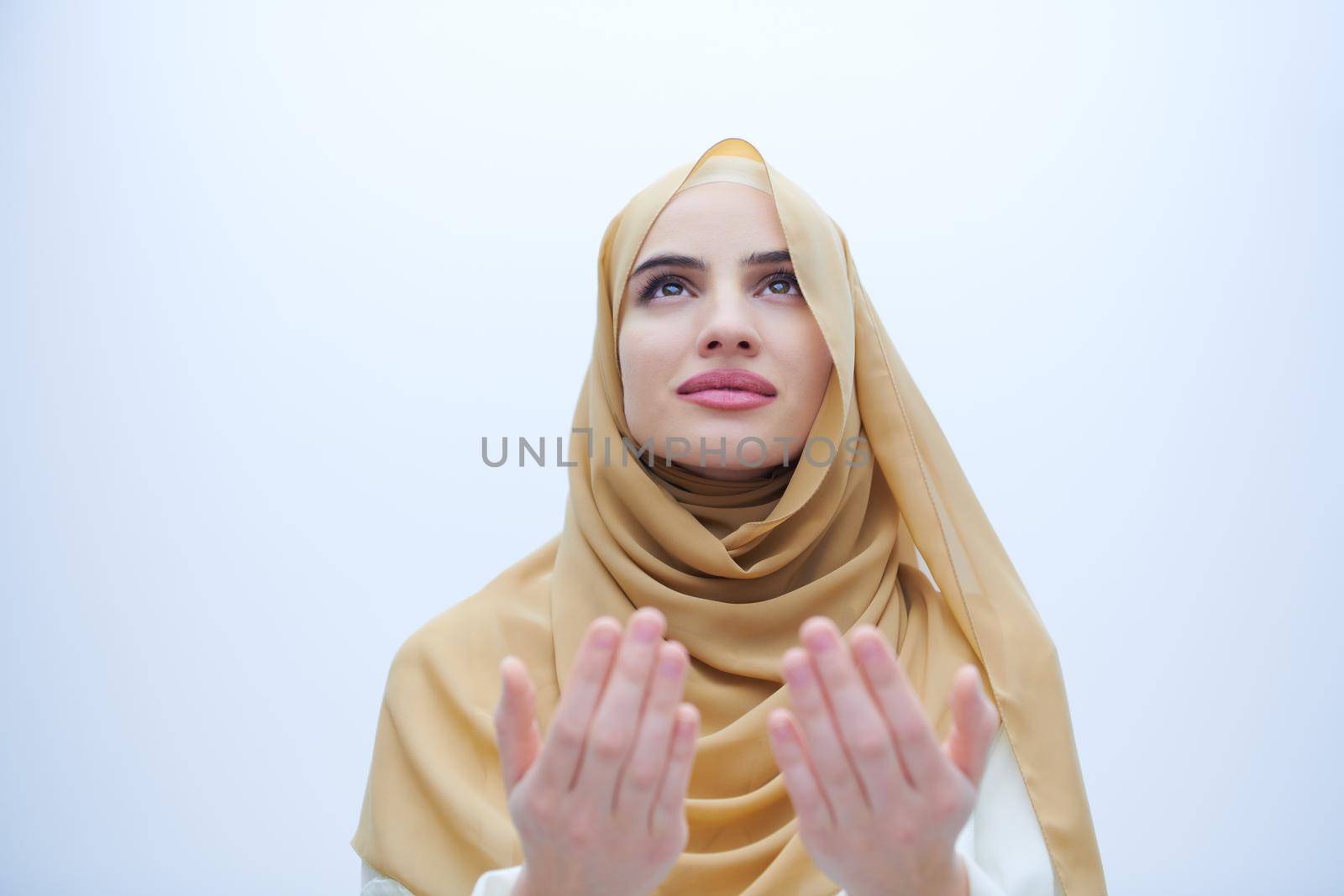muslim woman making traditional prayer to God by dotshock