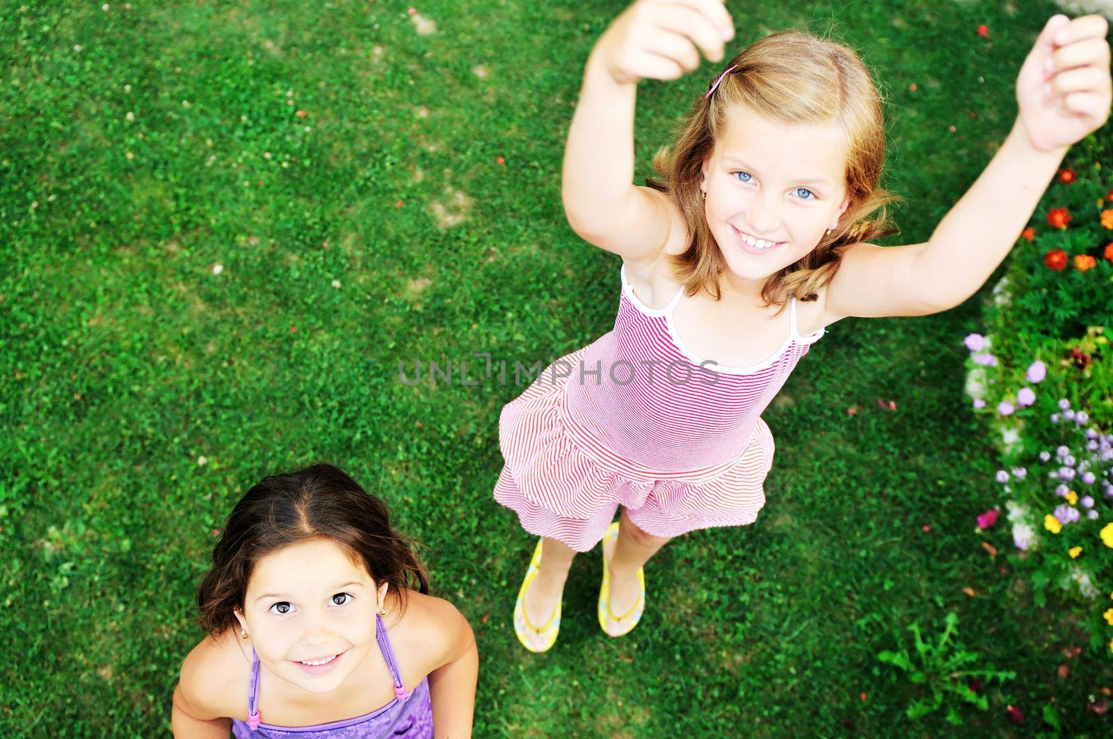 two happy young girls children  have fun outdoor in nature