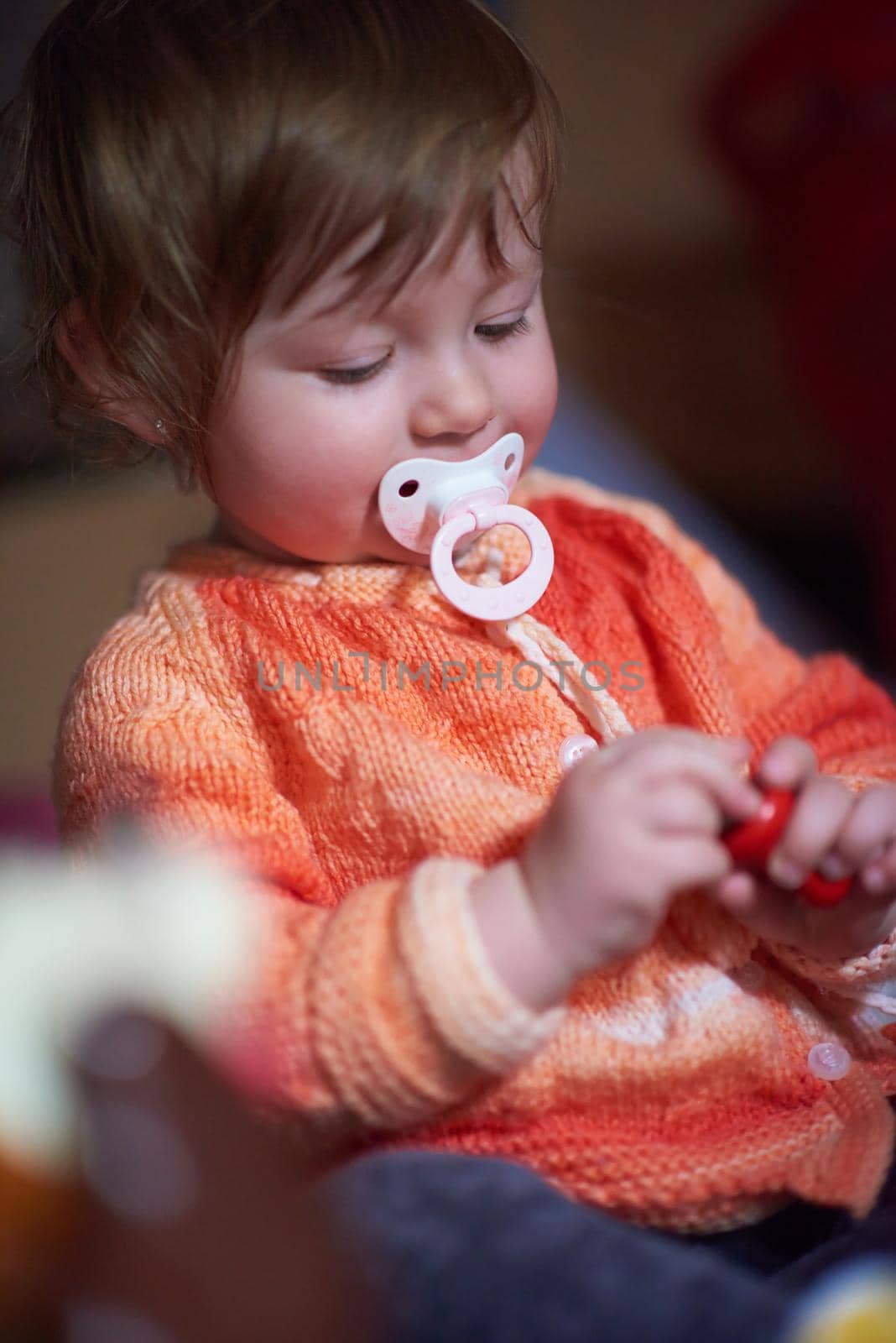 cute little child baby girl  playing with toys at home