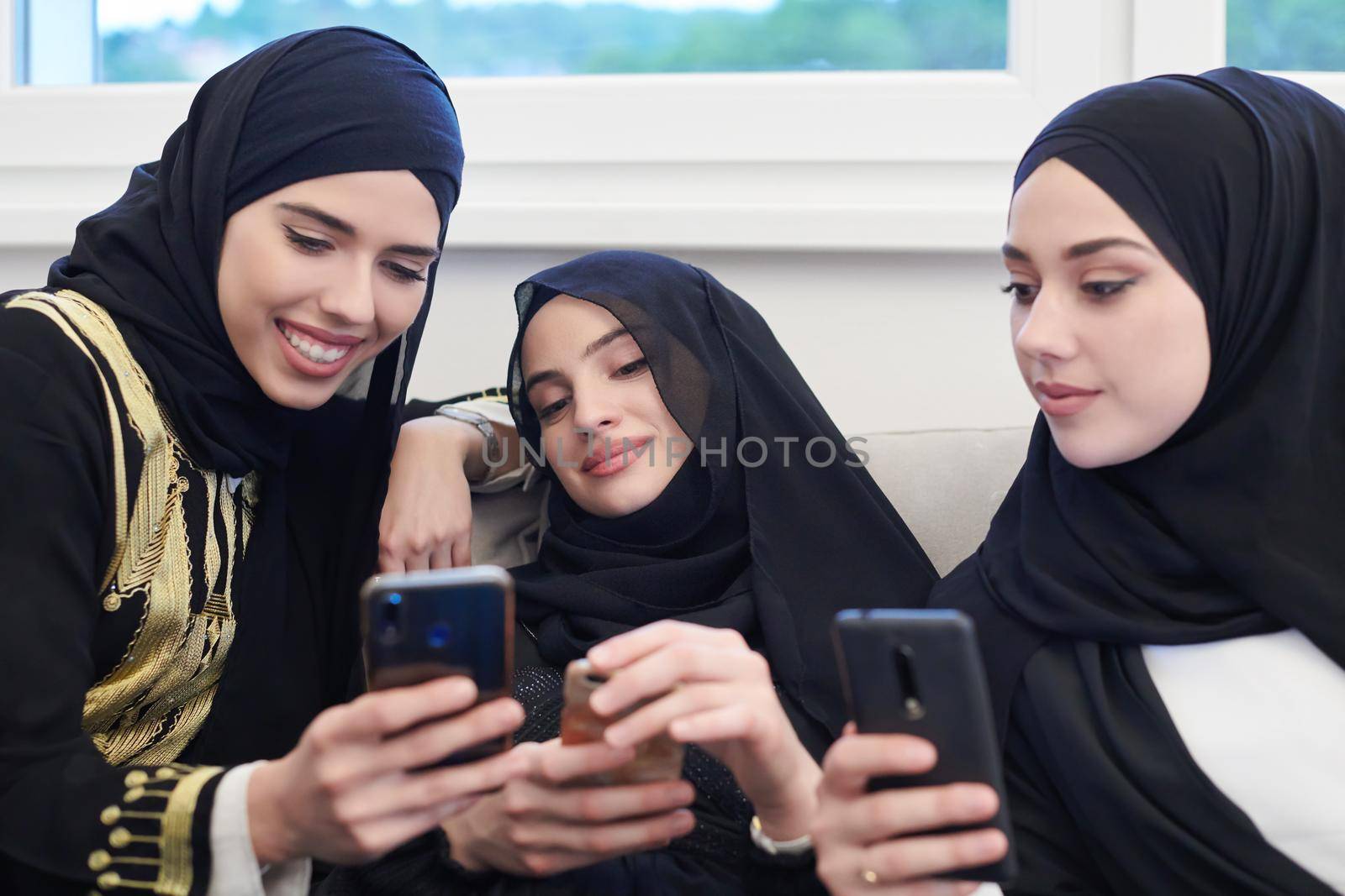 muslim women using mobile phone at home by dotshock