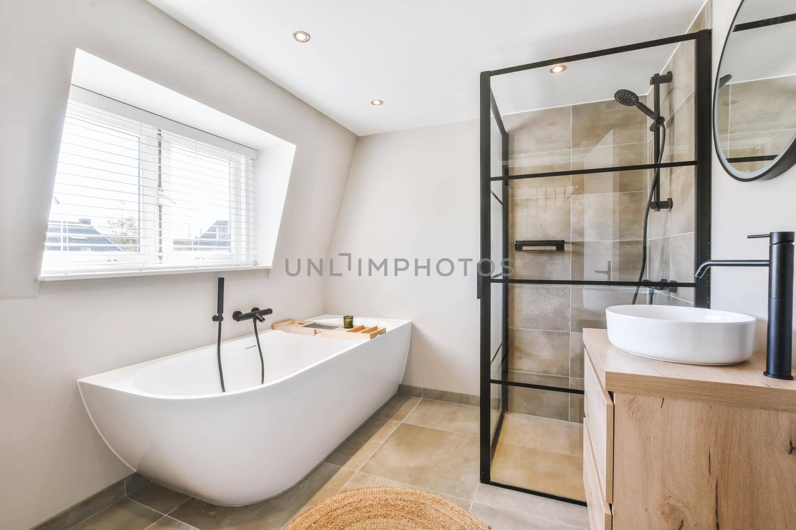 Delightful bathroom in a minimal style with a bathtub near the window