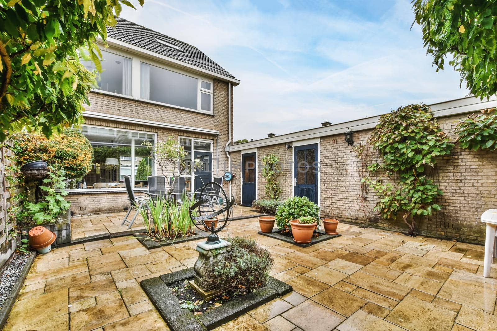 Delightfully beautiful courtyard with greenery and clearly laid cobblestones